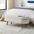 Banc de rangement ottoman ovale beige en lin avec pieds en bois d'hévéa et rangement caché