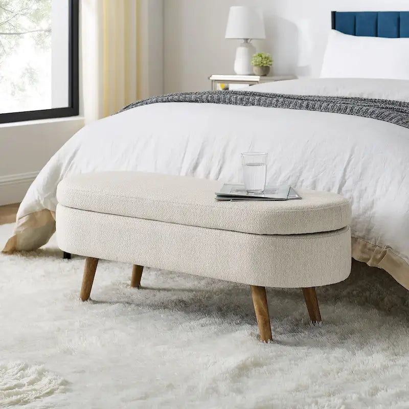 Banc de rangement ottoman ovale beige en lin avec pieds en bois d'hévéa et rangement caché
