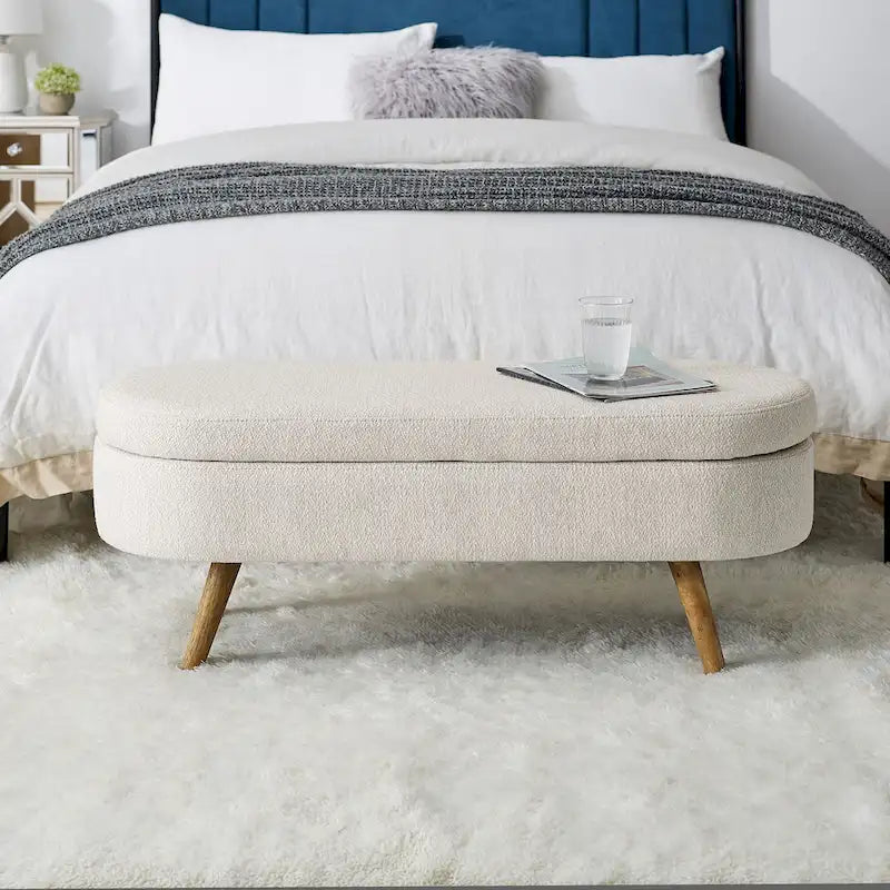 Banc de rangement ottoman ovale beige en lin avec pieds en bois d'hévéa et rangement caché
